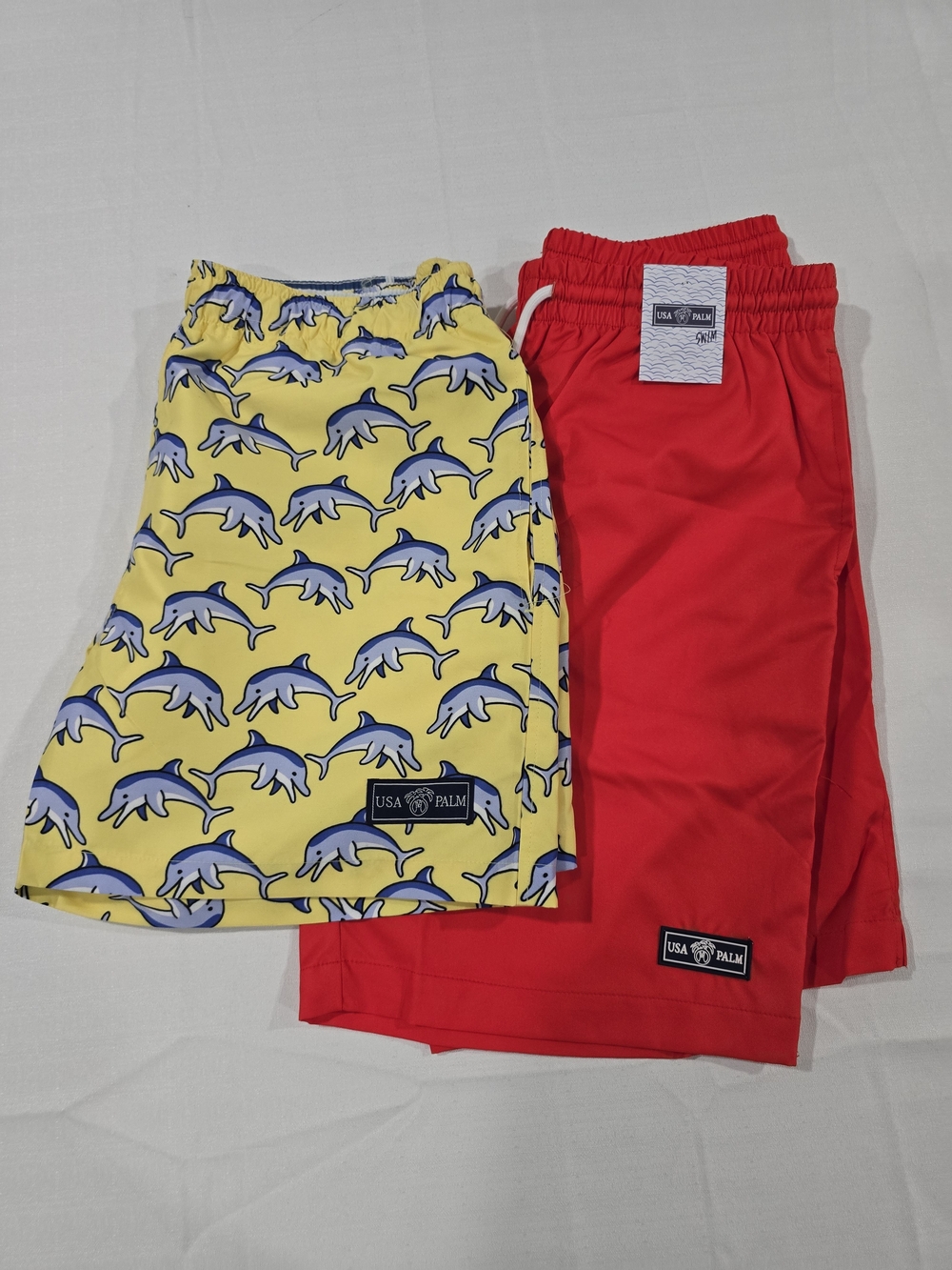 Bundle Of 2 Shorts USA Palm Swim Trunks - Yellow Dolphin & Red Solid | Small